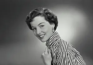 Collar Prints: Vintage Photograph. Woman in striped button shirt holding collar and smiling