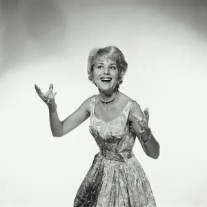 Express Prints: Vintage Photograph. Woman uses arms to express herself while smiling large