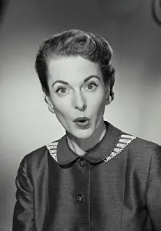 Shock Prints: Vintage Photograph. Woman wearing buttoned up blouse with surprised expression