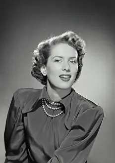 Vintage photograph. Woman wearing silk blouse and pearl necklace