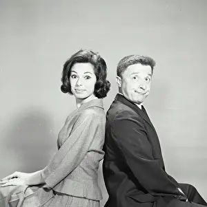 Grayscale Prints: Vintage Photograph. Young couple back to back with smug expression