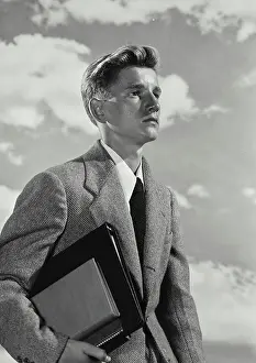 Shirt And Tie Prints: Vintage Photograph. Young man wearing blazer and tie holding stack of notebooks and binder