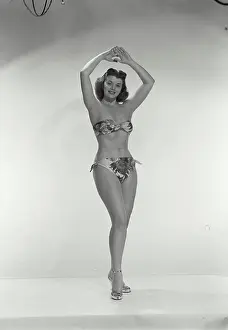 Grace Prints: Vintage Photograph. Young woman in bikini with arms above head