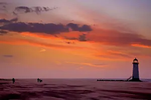 Coast Prints: Wales, Denbighshire, Talacre. A view from a windswept beach to Talacre Lighthouse at sunset