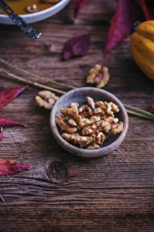 Nuts Prints: Walnuts in a little bowl on a rustic wooden table