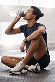 Runner Prints: Water bottle, fitness and gym man tired after a fitness training