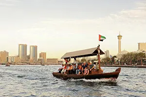 Evening Atmosphere Prints: Water taxi, ABRA, dhow on Dubai Creek between Bur Dubai and Deira