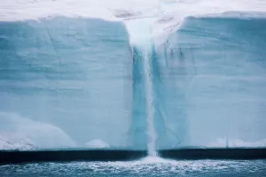 Iceberg Prints: A waterfall is created by a melting iceberg, Svalbard, Norway Svalbard, Norway