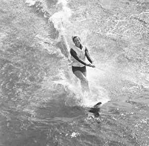 Grownups Prints: Waterskiing in the 1960s. A young woman is waterskiing. Sweden July 1964