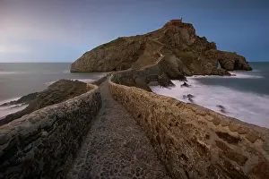 Magnificent Prints: Waves beating against medieval stone bridge leading to small rocky island with San Juan de Gaztelugatxe hermitage