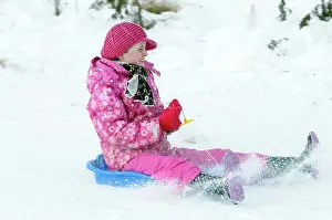 Climate Prints: Weather, Winter, Snow, Young Girl Sledding Down Hill. Perth, Scotland
