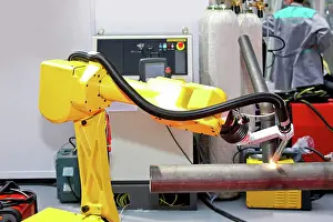 Robot Prints: Welding pipe Yellow robotic arm for automatic welding pipes Copyright: xZoonar