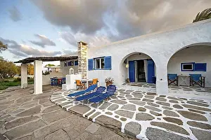 Holidays Prints: White Cycladic house with terrace with chairs and sun loungers