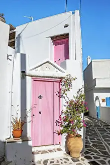 Entrances Prints: White Cycladic houses with pink doors and windows and flower pots