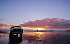 Waves Prints: White Ute parked on the beach and lone person standing by the water at sunset