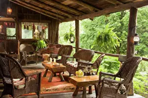 Terrace Prints: Wicker tables and chairs set on veranda of timber house