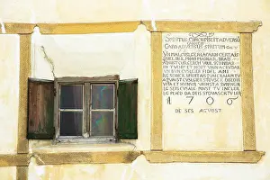 Inscription Prints: Window and inscription on old painted stone 17th century building in the Engadine Valley in the village of Guarda
