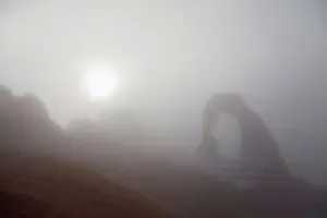 Utah Prints: Winter fog visually obscures a view of Delicate Arch, Arches National Park, Utah