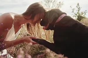 Best Prints: woman with her big brown labrador dog in field