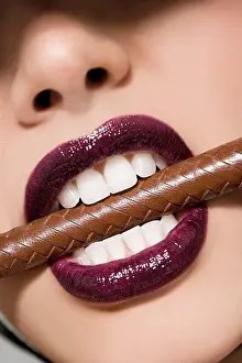Tooth Prints: Woman biting a riding crop