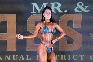 Body Building Prints: Woman bodybuilder perform onstage during a regional bodybuilding competition organised by World Fitness Federation of