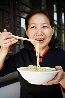 Food Prints: Woman with bowl of noodles and chopsticks eating