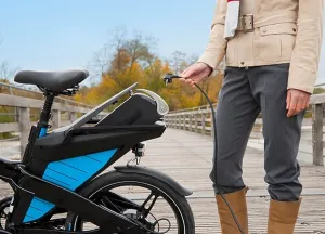 Connexions Prints: Woman charging electric bike outdoors