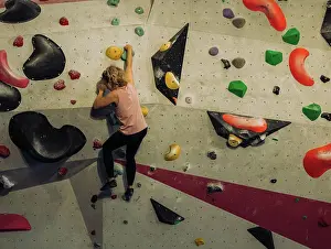 36 39 Years Old Prints: woman climbing a boulder wall indoors at a climbing centre