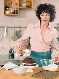 Assured Prints: Woman decorating chocolate cake with dairy cream