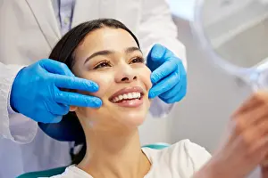 Tooth Prints: Woman, dentist and smile with mirror for dental surgery in clinic for teeth whitening and treatment with doctor