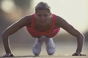 Stretches Prints: Woman doing push-ups outdoors