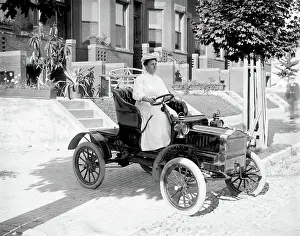 Archives Prints: Woman driving an automobile in early 1900s
