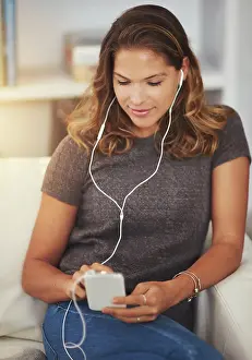 Network Prints: Woman, earphones and streaming music on couch