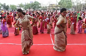 Hindu Prints: Woman and girls dancing as they are participated in a Bihu folk dance workshop ahead of Rongali Bihu Festival on April