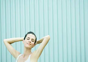 Verticals Prints: Woman with hands behind head and eyes closed, smiling