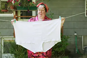 Eye Glasses Prints: Woman hanging oversized underwear on a clothesline