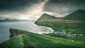 Hike Prints: Woman hikes to village Gjogv on Eysteroy with gorge, sea and mountains, Faroe Islands