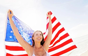 Holding Up Prints: Woman holding American flag