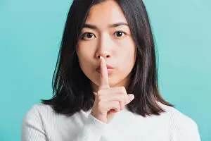 Lips Prints: woman holding index finger on her mouth lips