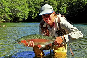 30 Years Prints: Woman holding rainbow trout, New Zealand