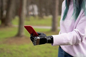 Handicapped Prints: Woman holding smart phone with artificial limb