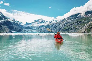 Baby Boomer Prints: Woman kayaking in Glacier Bay National Park with glacier in background