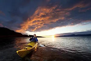 Amuse Prints: Woman kayaking in still lake