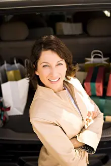 Model Release Prints: Woman loading gifts into vehicle