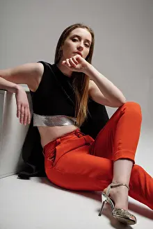 Baby Boomer Prints: Woman model dressed in red trousers and black jacket posing in studio