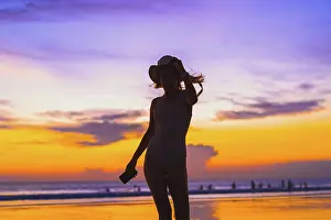 26 29 Years Old Prints: Woman in a panama hat on the ocean beach. Sunset in Bali