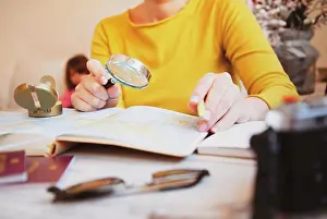 Globe Prints: Woman planning tour with travel map at home - Mum looking for new countries to explore with her family - Concept of