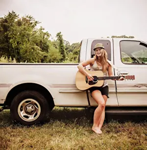 Vehicle Prints: Woman playing guitar in front of her truck