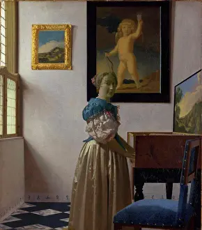 Blonde Hair Prints: Woman playing on piano by Jan Vermeer