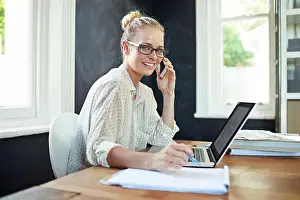 Home Office Prints: Woman, portrait and laptop in home office with phone call for business networking
